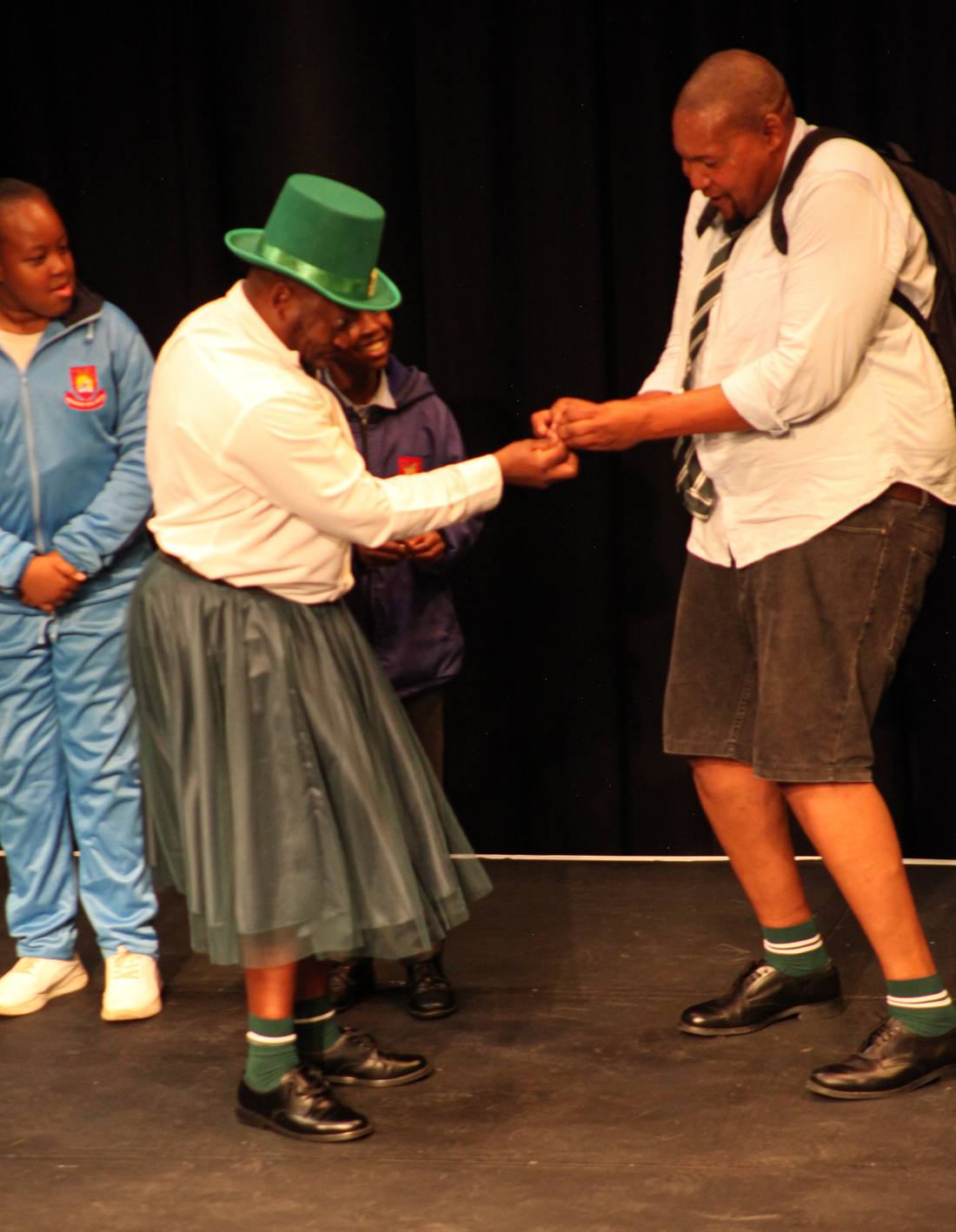 Two performers acting out a money exchange